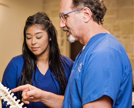 Orthopedic spine specialists discussing physical rehab therapy for a patient in Mount Pleasant, Texas.